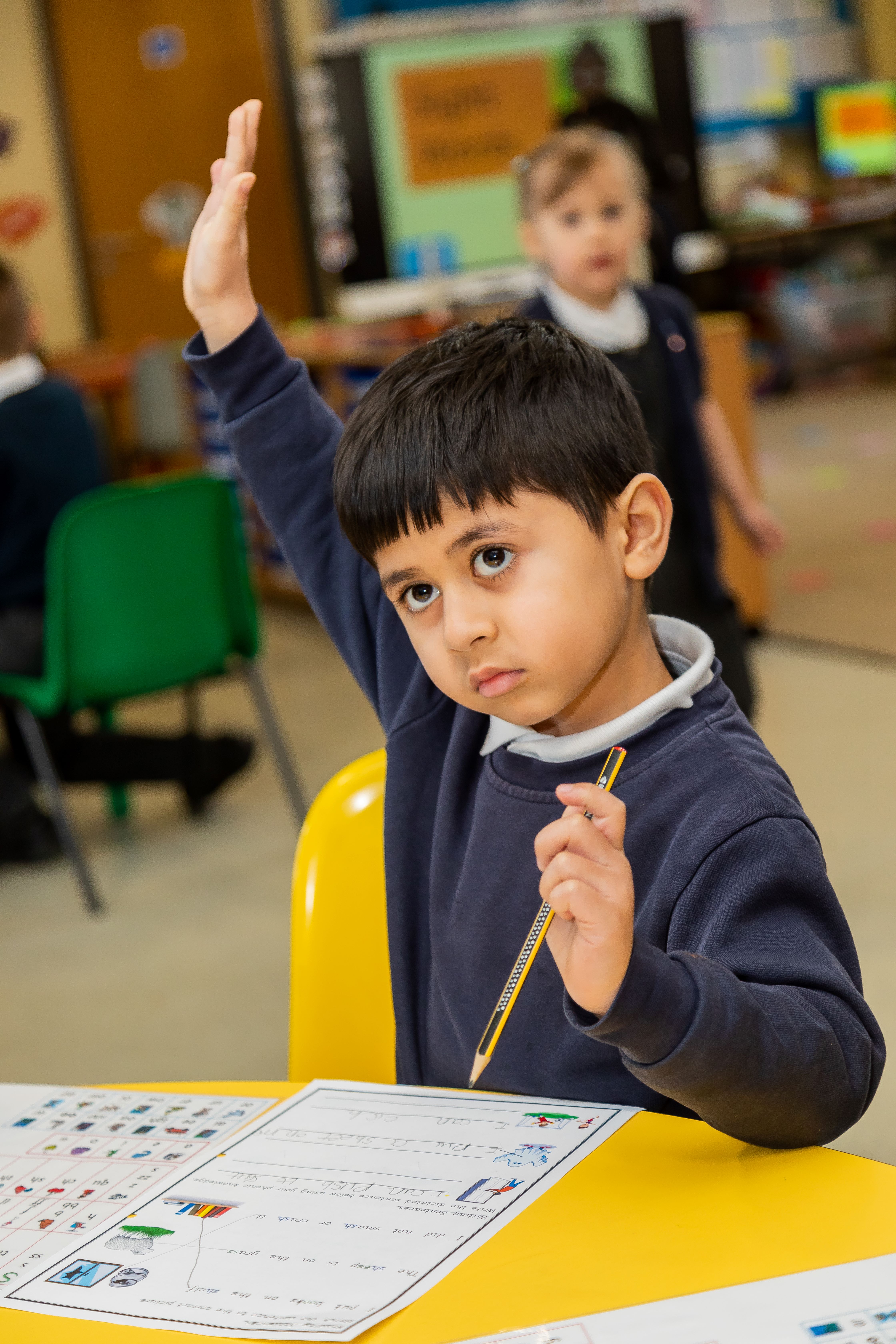 Pupil with hand up in class KAM_5394